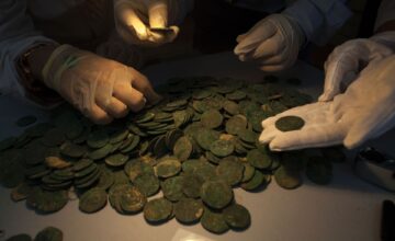 Roman era bronze coins are displayed at the archaeological museum in Sevilla on April 28, 2016 following their discovery during development works for pipelines and installations in the El Zaudine park in Tomares on the outskirts of Sevilla.
Some 19 amphorae, nine of which were retrieved fragmented, containing around 600kg of bronze coins from the fourth century AD were found by employees using earth moving machinery in an underground space covered by bricks and ceramic filler. / AFP PHOTO / Gogo Lobato